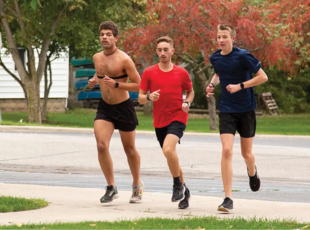 Three students running together