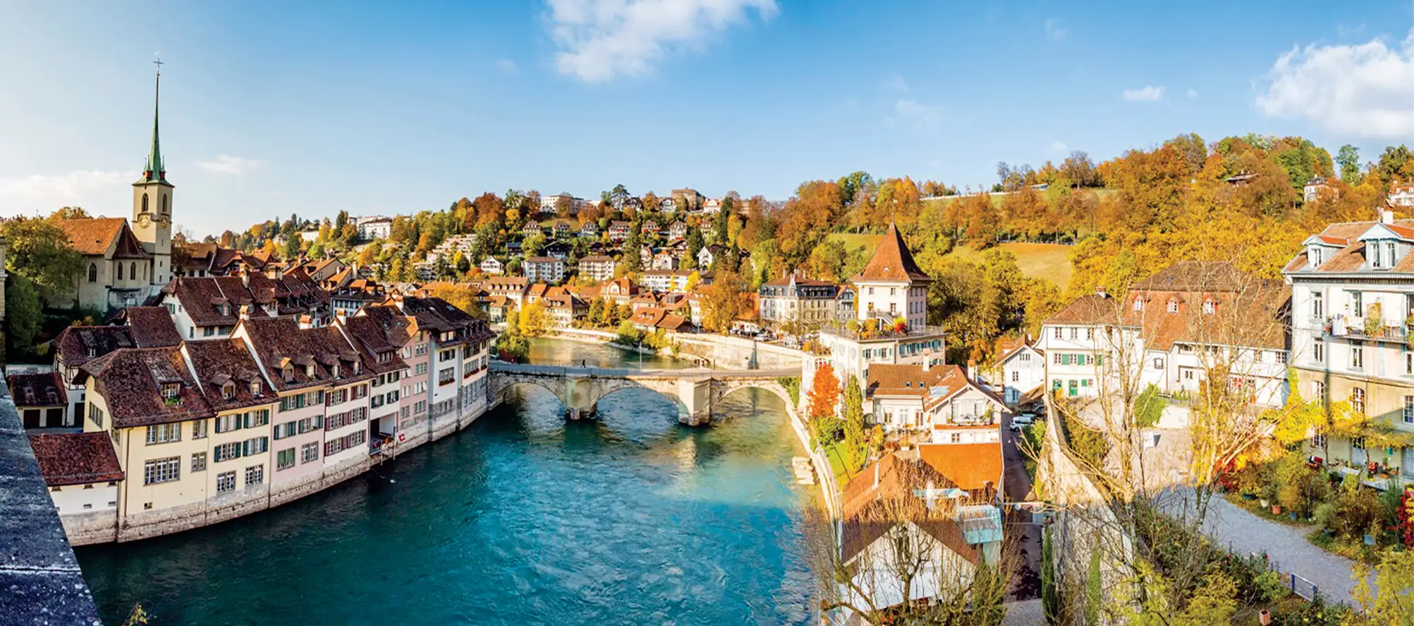 Panoramic view of canal in Switzerland with various types of houses lining the sides