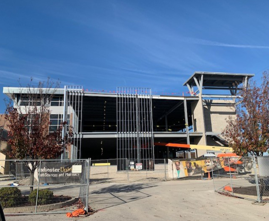 front view of building with steel beams during construction